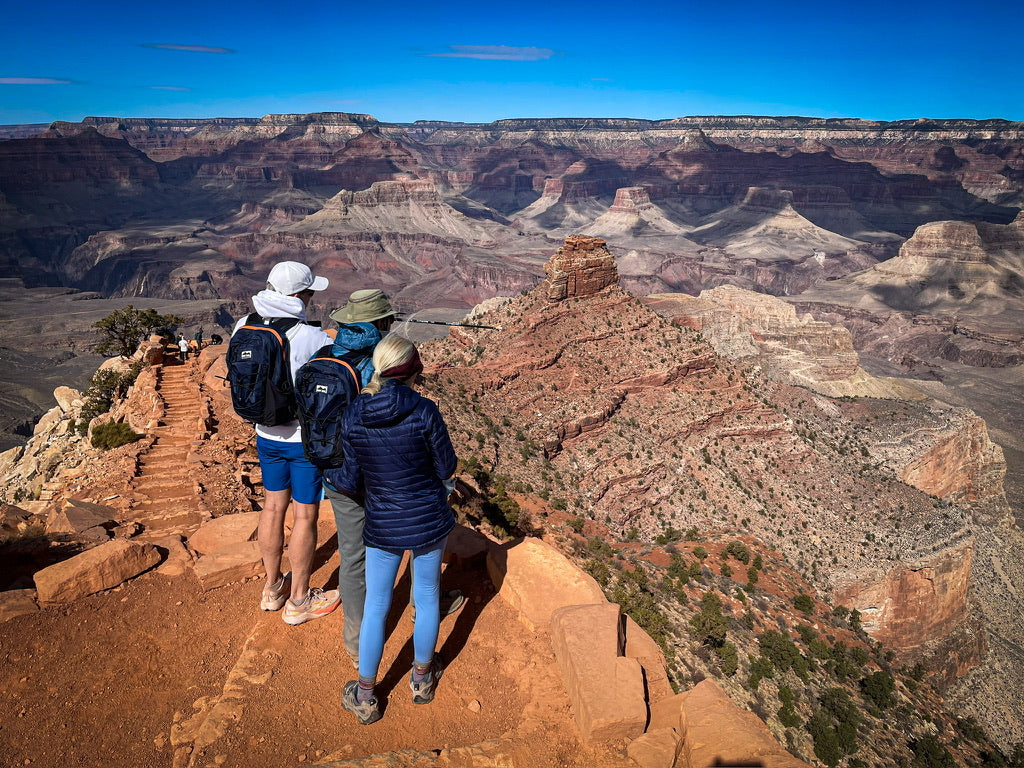 Hiker wearing a sage green Canyon Elite 25 pack overlooking the Grand Canyon