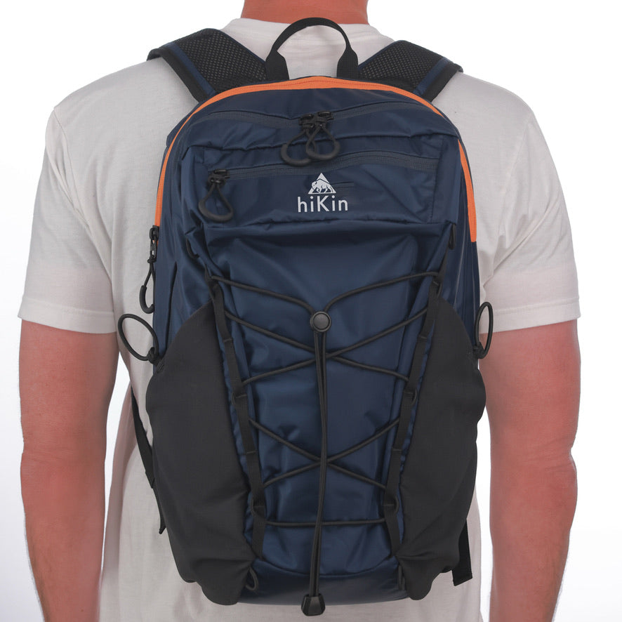 Hiker wearing a sage green Canyon Elite 25 pack overlooking the Grand Canyon