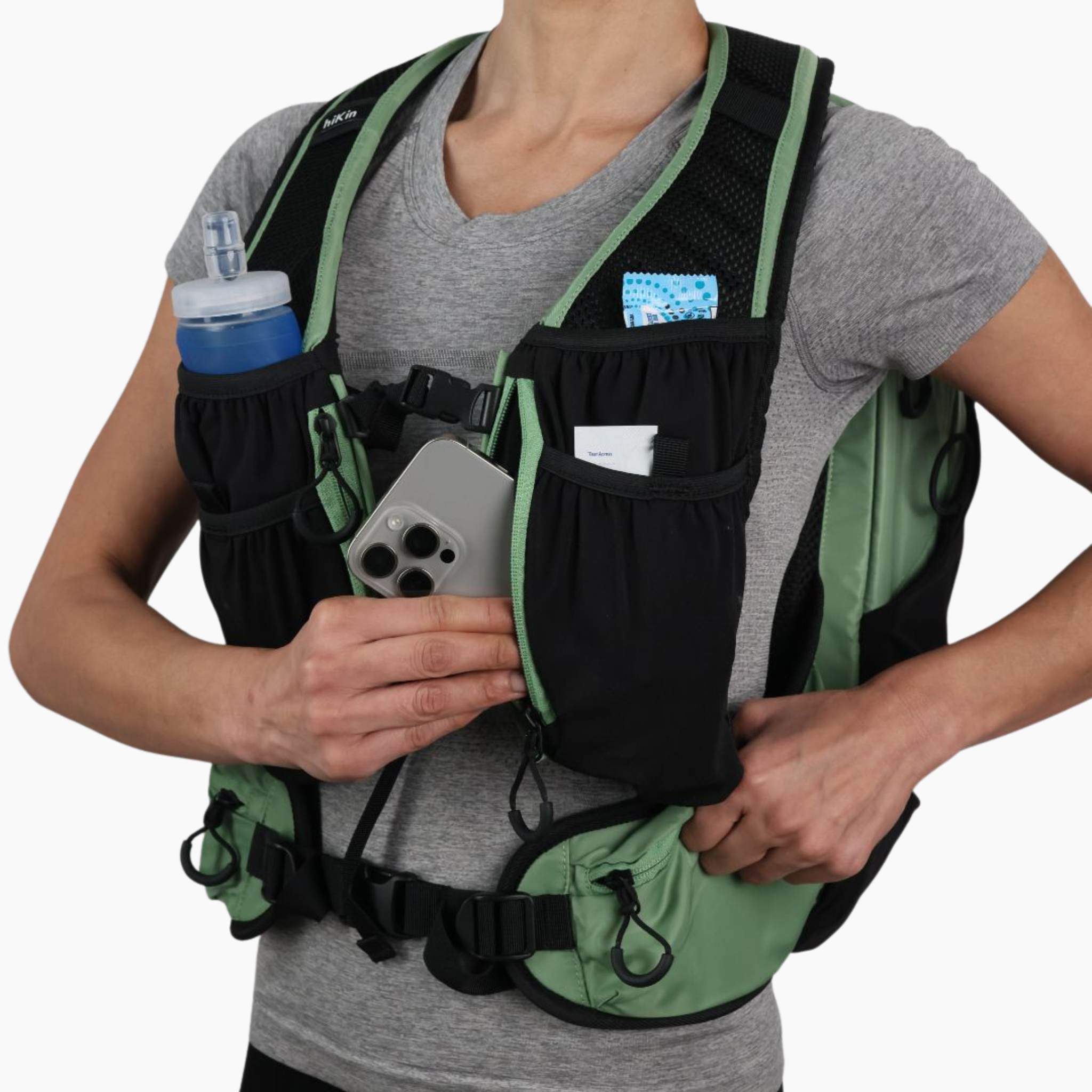 Sage green Canyon Elite 25 hiking pack with water bottle, phone, and essentials stored in the front pockets