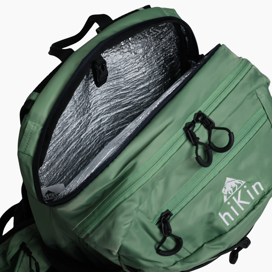 Open insulated hydration compartment inside the sage green Canyon Elite 25 backpack