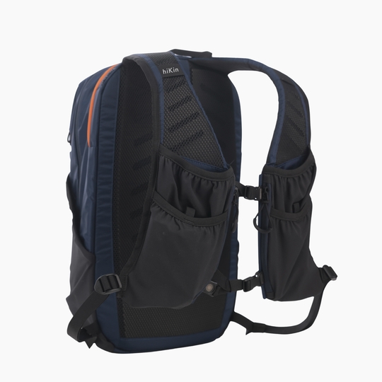 A hikin backpack shown from the back, featuring dark navy blue and black mesh panels, side pockets, and shoulder straps, photographed against a solid white background.